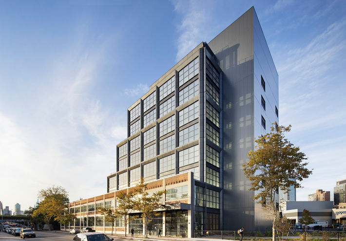 Exterior View of Gantry Point located in Long Island City, NY. Street view of the nine-story glass window building with industrial characteristic based. The photo was taken with early morning light gently touching the front of the building. Architect: Studios Architecture, Photography by Ines Leong of L-INES Photo.