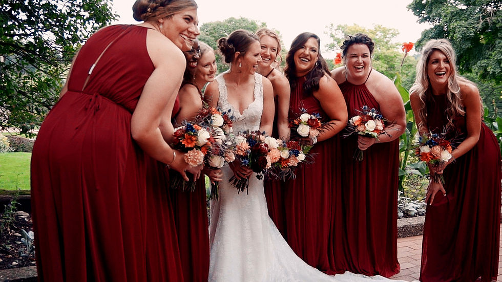 Emily laughs with her bridesmaids outdoors.