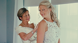 Bride with her mother putting on dress at Seaview, a Dolce Hotel in New Jersey, captured by luxury wedding videographer Monar