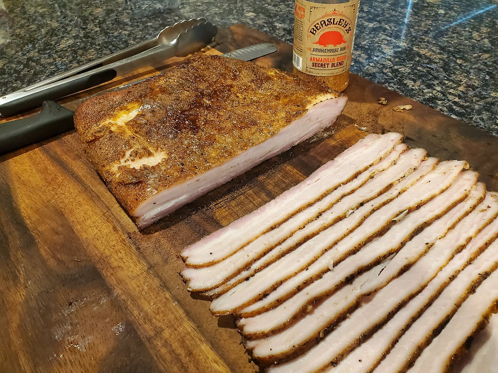 Pork belly seasoned, smoked, and sliced for bacon.