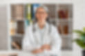 happy-middle-aged-woman-doctor-sitting-at-the-desk-2023-11-27-05-22-57-utc.jpg
