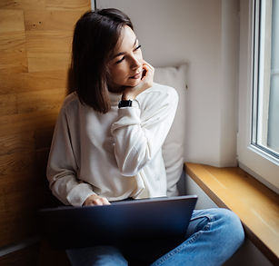 Woman sitting, looking distracted and emotionally drained, reflecting the toll of daily life on women's mental health
