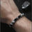 Thumbnail: Unisex Sovereign's Gaze bracelet shown on the wrist to highlight the industrial elegance of the Eagle Eye stones and Stainles