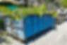 Garbage container bin latch with truck full of garden refuse, woods, chopped trees for dis