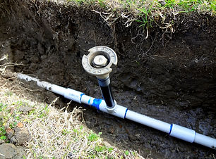 Sprinkler exposed in open trench.jpg