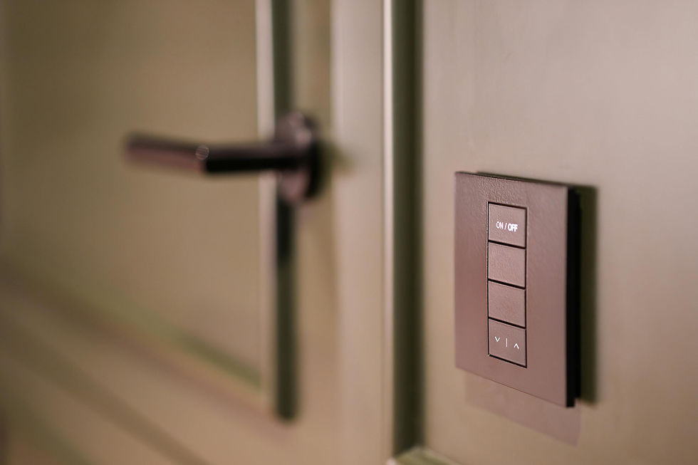 Close-up of a frequently touched surface with a modern light switch and door handle, highlighting the importance of sanitising high-touch areas in commercial cleaning.