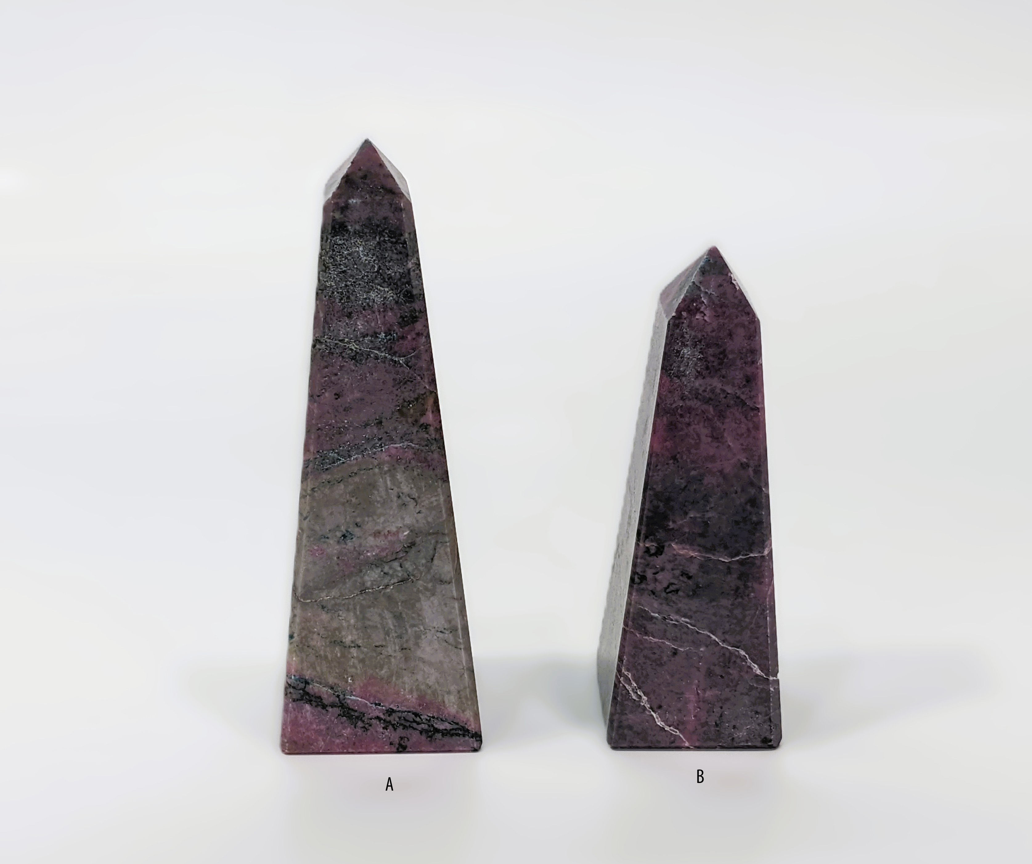 Rhodonite Obelisk with pink and black veining, manganese-rich silicate, symbolizing grounding, emotional healing, and heart-c