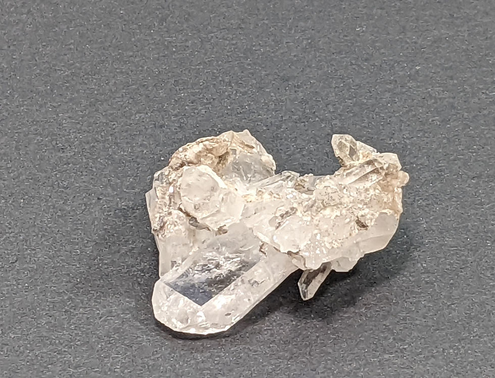 Thumbnail: Clear quartz crystal cluster with smooth, polished edges.