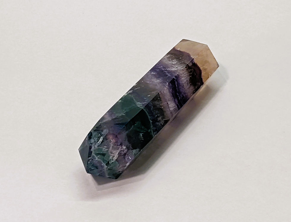 Thumbnail: Double terminated Rainbow Fluorite crystal point with natural purple, green, and blue layers.