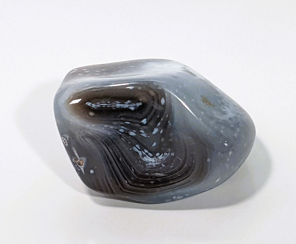 Thumbnail: Botswana Agate tumbles featuring intricate bands of cream, gray, and peach.