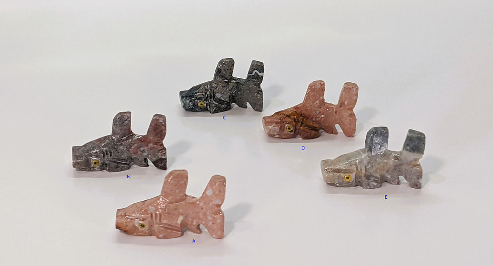 Pocket-sized soapstone hammerhead shark carving, symbolizing focus and unique perspective.