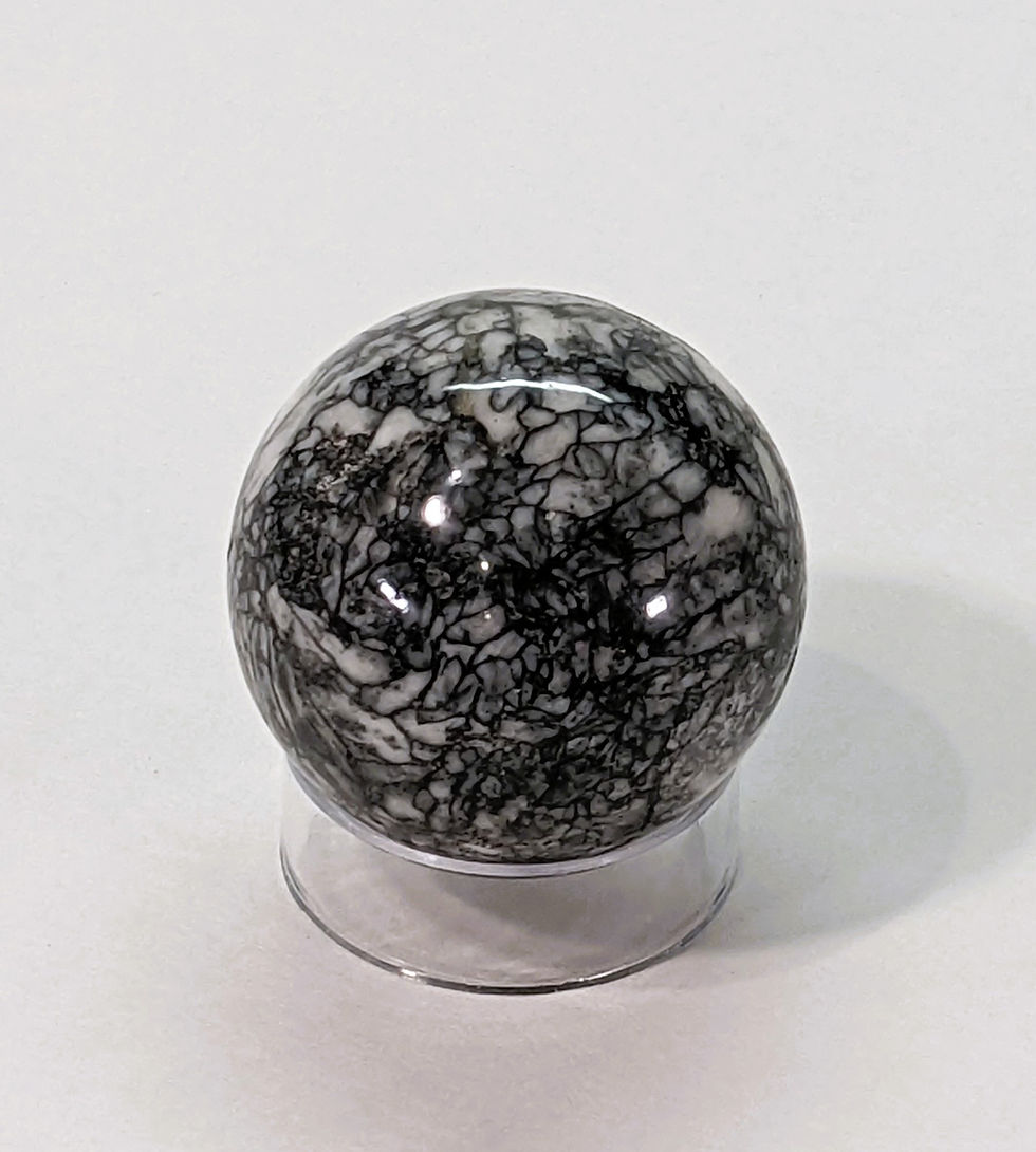 Thumbnail: Polished Pinolite sphere with natural black and white mineral patterns.