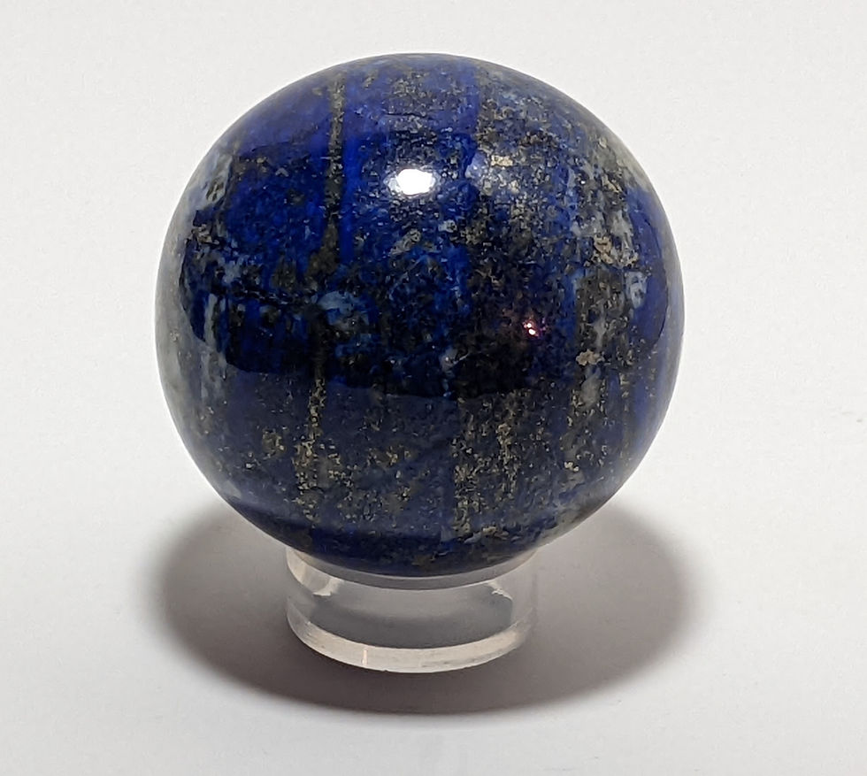 Thumbnail: Polished sphere of lapis lazuli with blue tones and white and gold sparkle