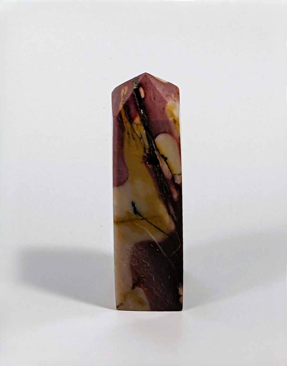Thumbnail: Polished Mookaite point with natural swirling patterns and rich, warm colors.