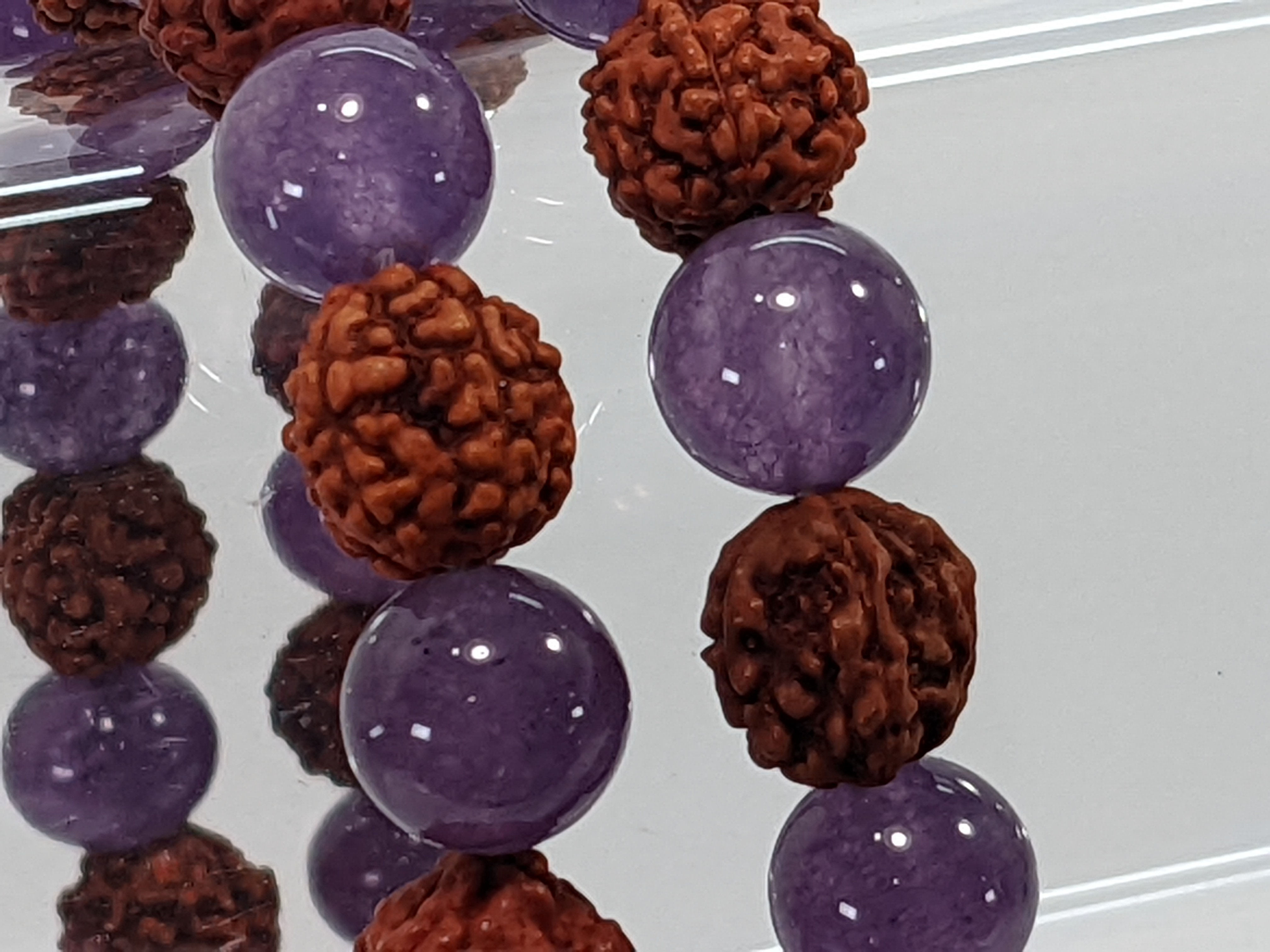 Amethyst rudraksha bracelet combining calming amethyst with sacred rudraksha beads. At jujujems.