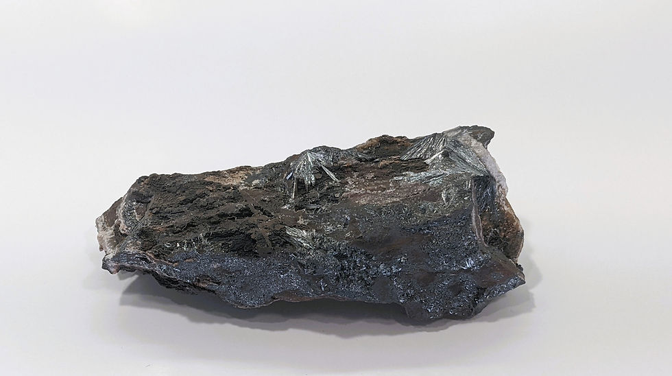 Thumbnail: Specular Hematite rough specimen displaying sharp, bladed crystals with a reflective metallic surface.