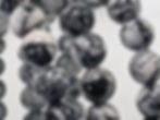 Natural Pinolite beaded bracelet with contrasting black and white patterns.