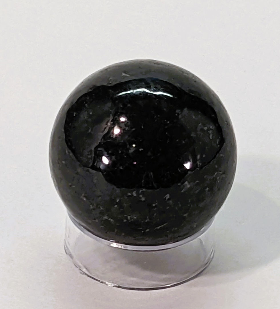 Polished Nuumite sphere with deep black and iridescent flashes of gold and green.