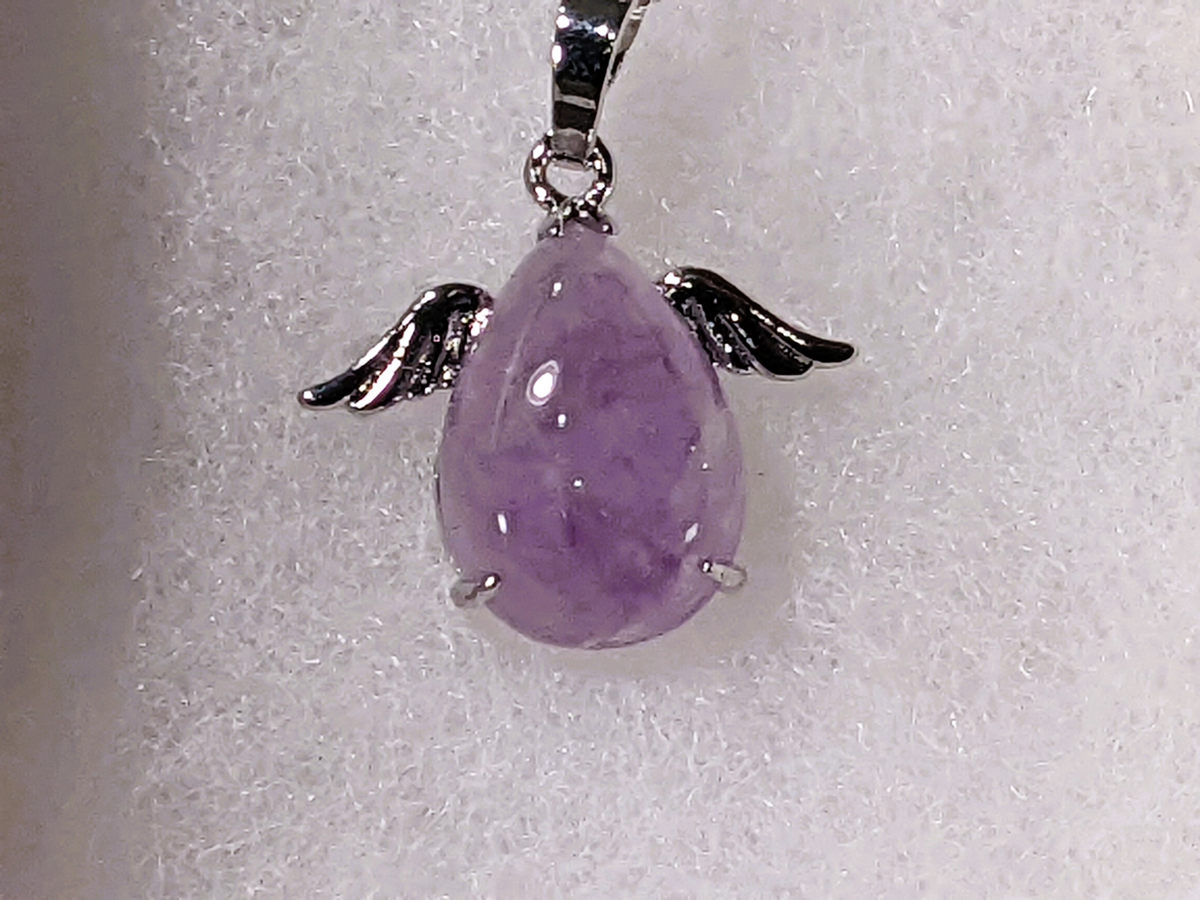 Amethyst teardrop angel pendant with rich purple tones, known for calming energy and spiritual clarity. At jujujems.