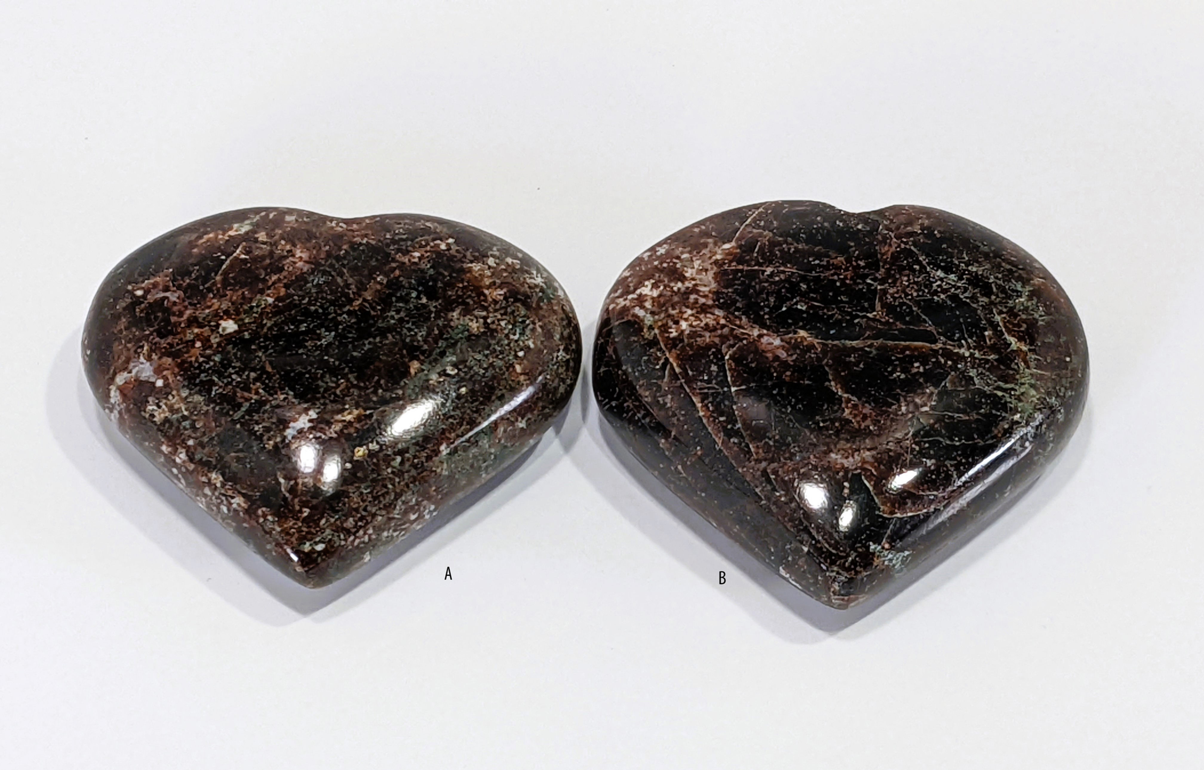 Polished Garnet Hearts, radiating deep red tones and showcasing natural crystal reflections.
