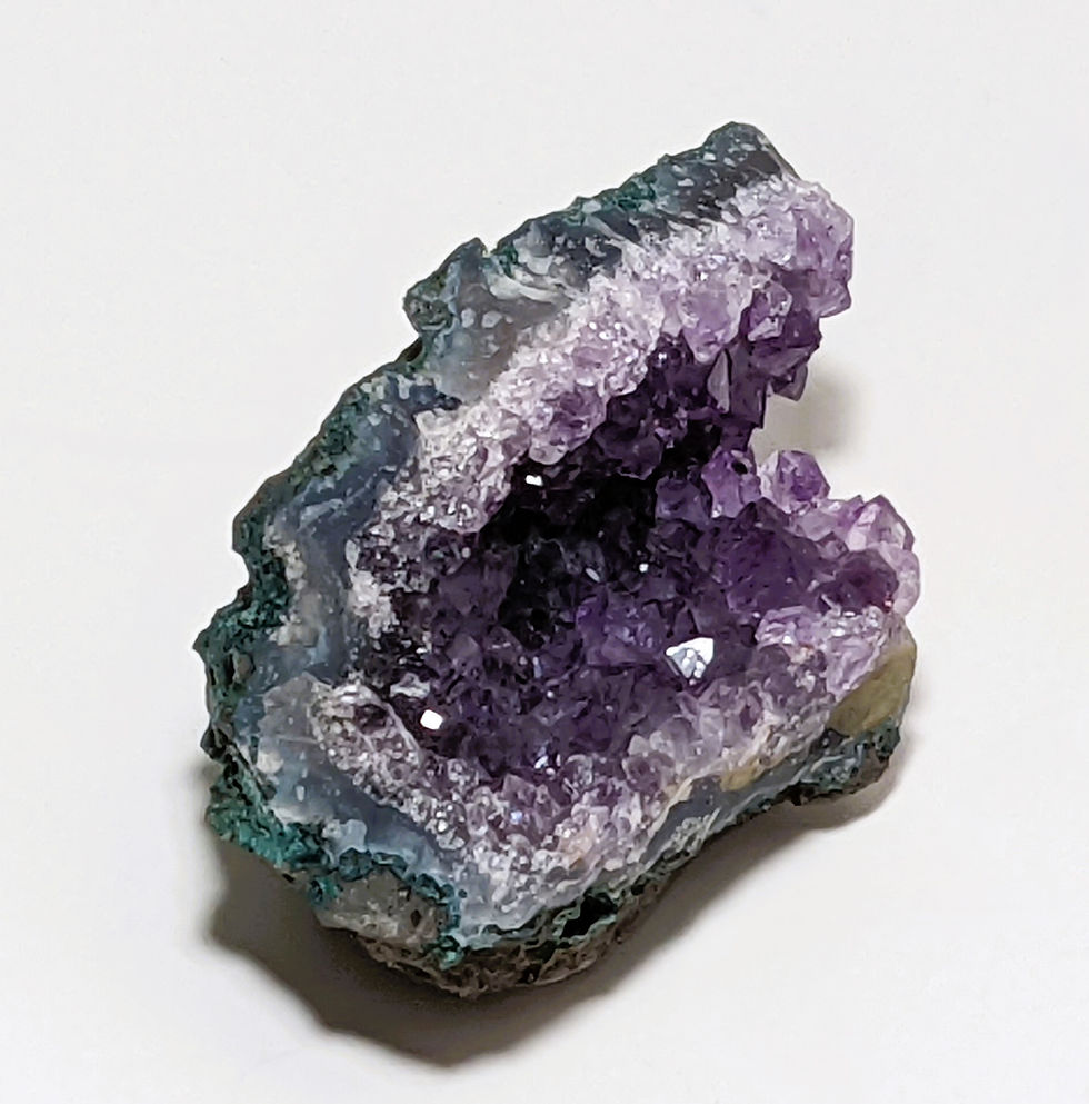 Sparkling Amethyst cluster with deep purple crystal points, showing natural growth patterns.