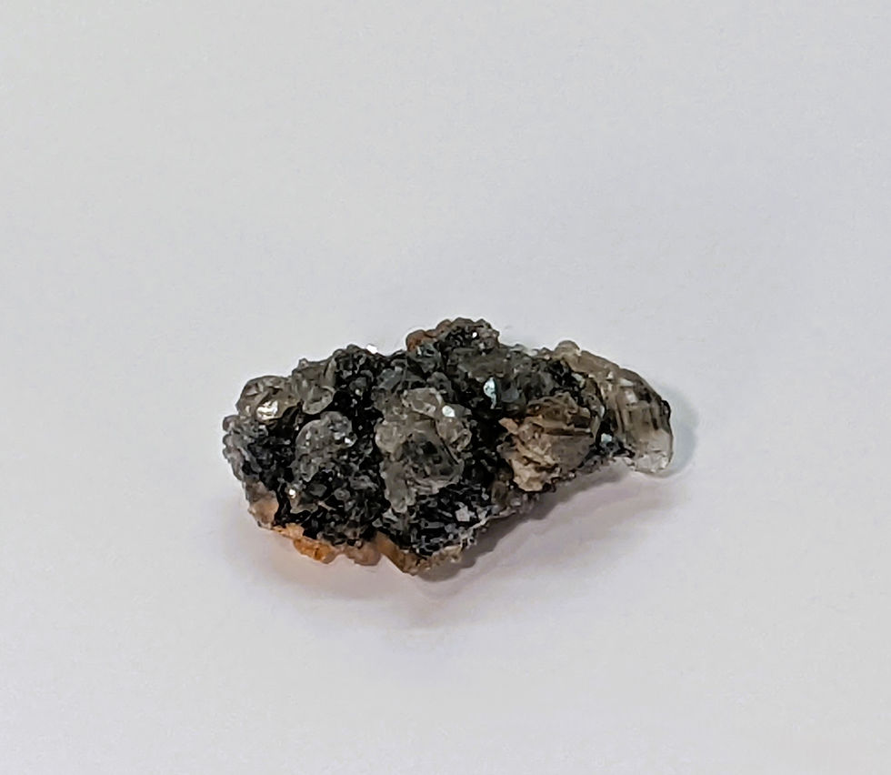 Thumbnail: Moroccan Barite rosettes accented by silvery Skutterudite crystals.