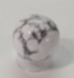Howlite Sphere from jujujems: promotes calm, reduces stress, and enhances patience with its soothing and balancing energy.