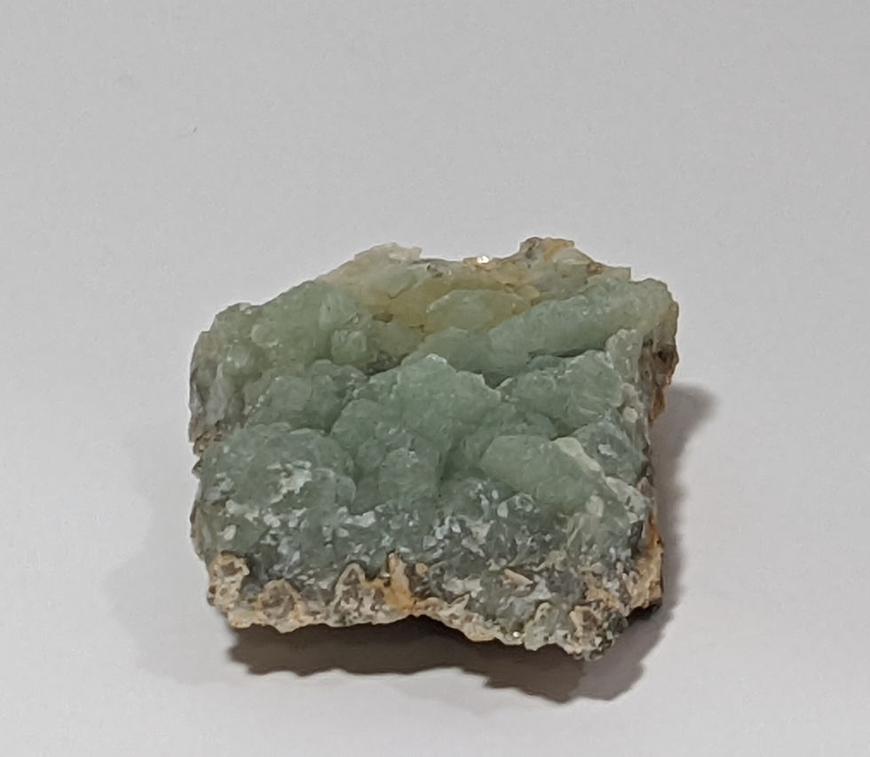 Thumbnail: Rough Prehnite mineral piece in soft green hues with matrix