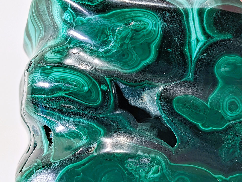 Thumbnail: Polished malachite freeform highlighting smooth, glossy textures with vivid green marbling and natural striations.