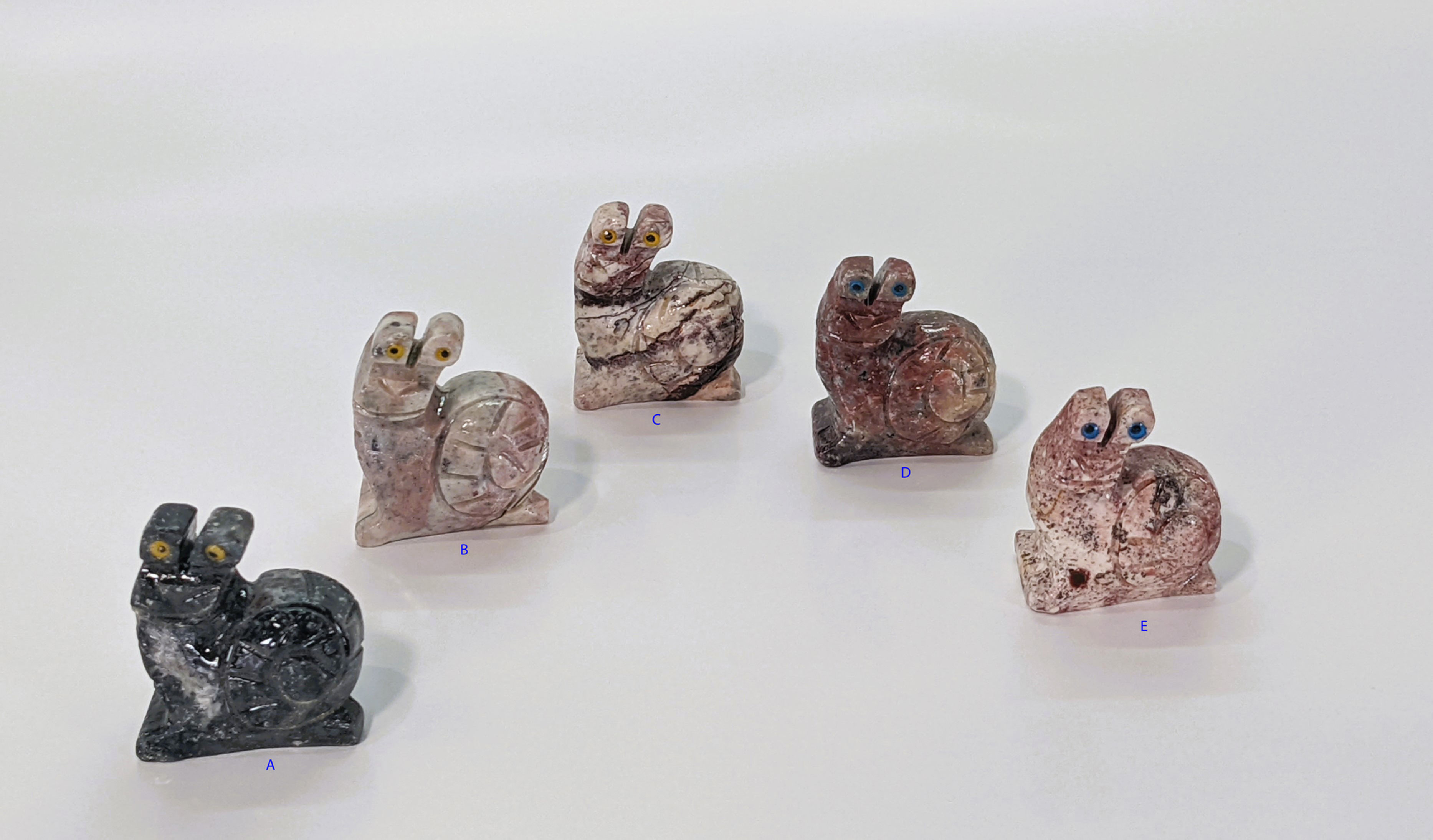 Miniature soapstone snail carving, symbolizing patience, flow, and mindful movement.