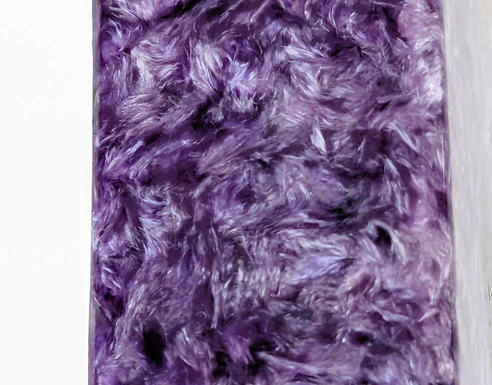 Thumbnail: Polished Charoite Obelisk with swirling purple patterns and natural inclusions, displayed against a neutral background.