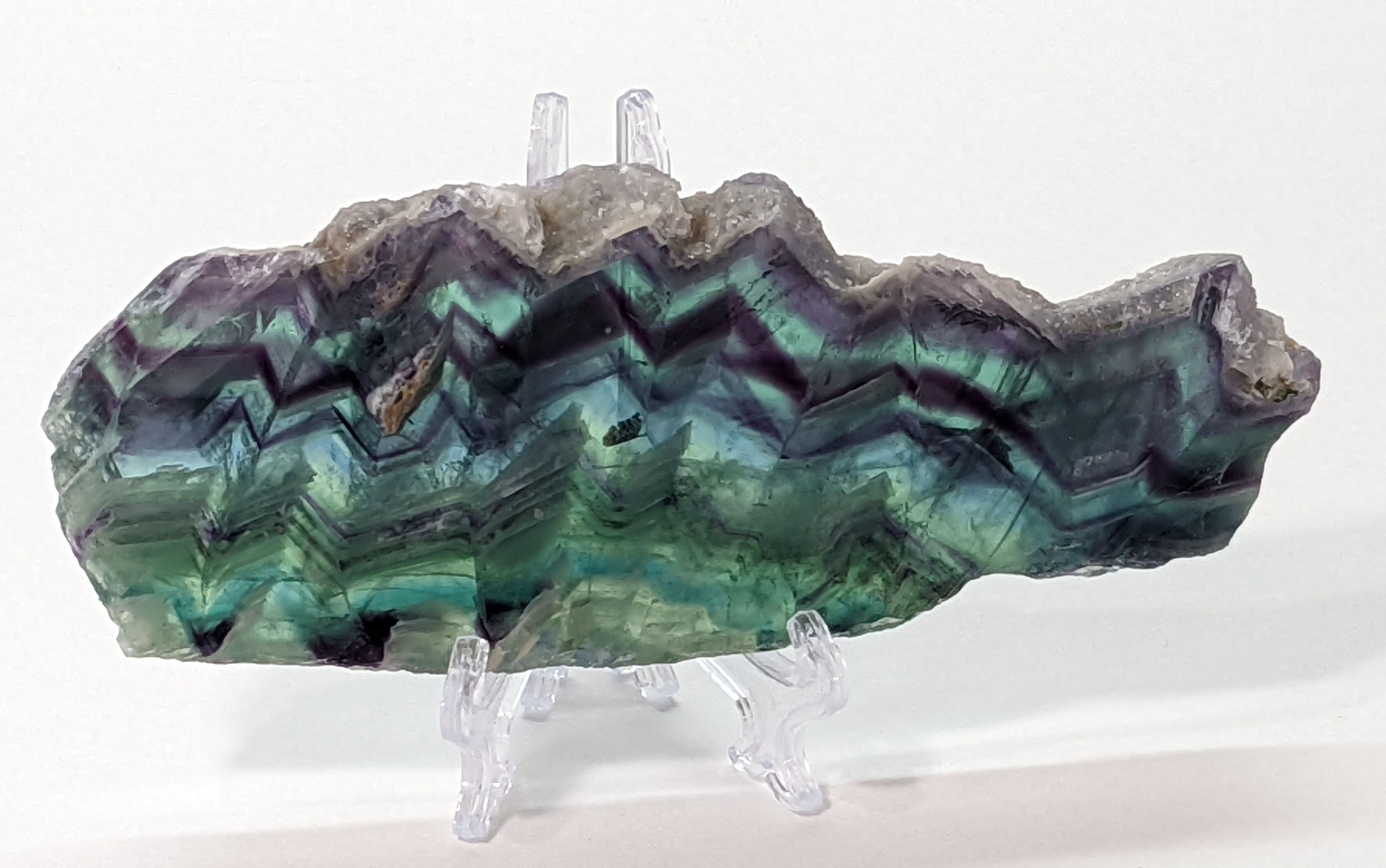 Rainbow Fluorite slice crystal with polished edges and layered colors.