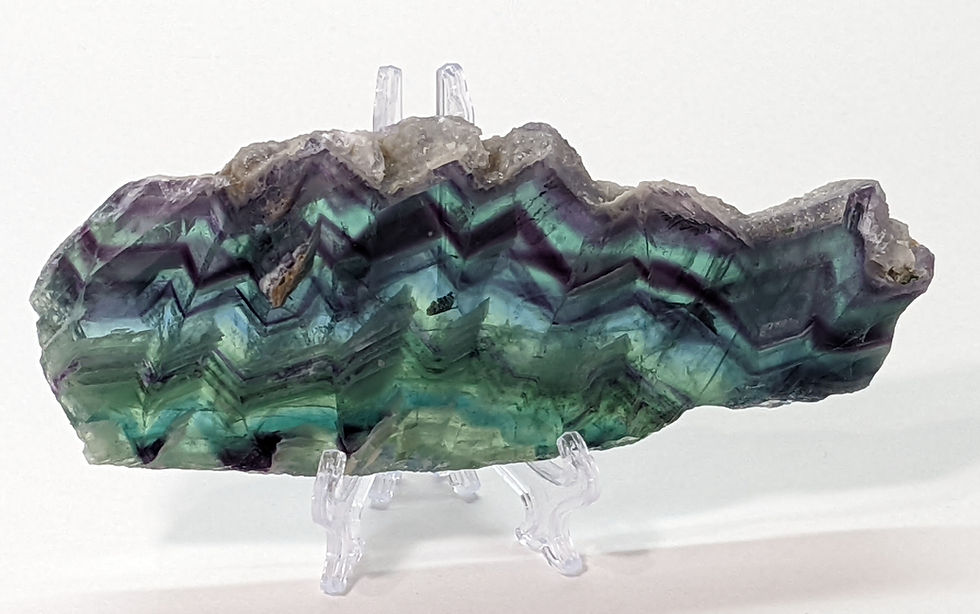 Thumbnail: Rainbow Fluorite slice crystal with polished edges and layered colors.