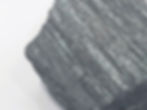 Rough Specular Hematite specimen with silvery metallic sparkle and layered texture.