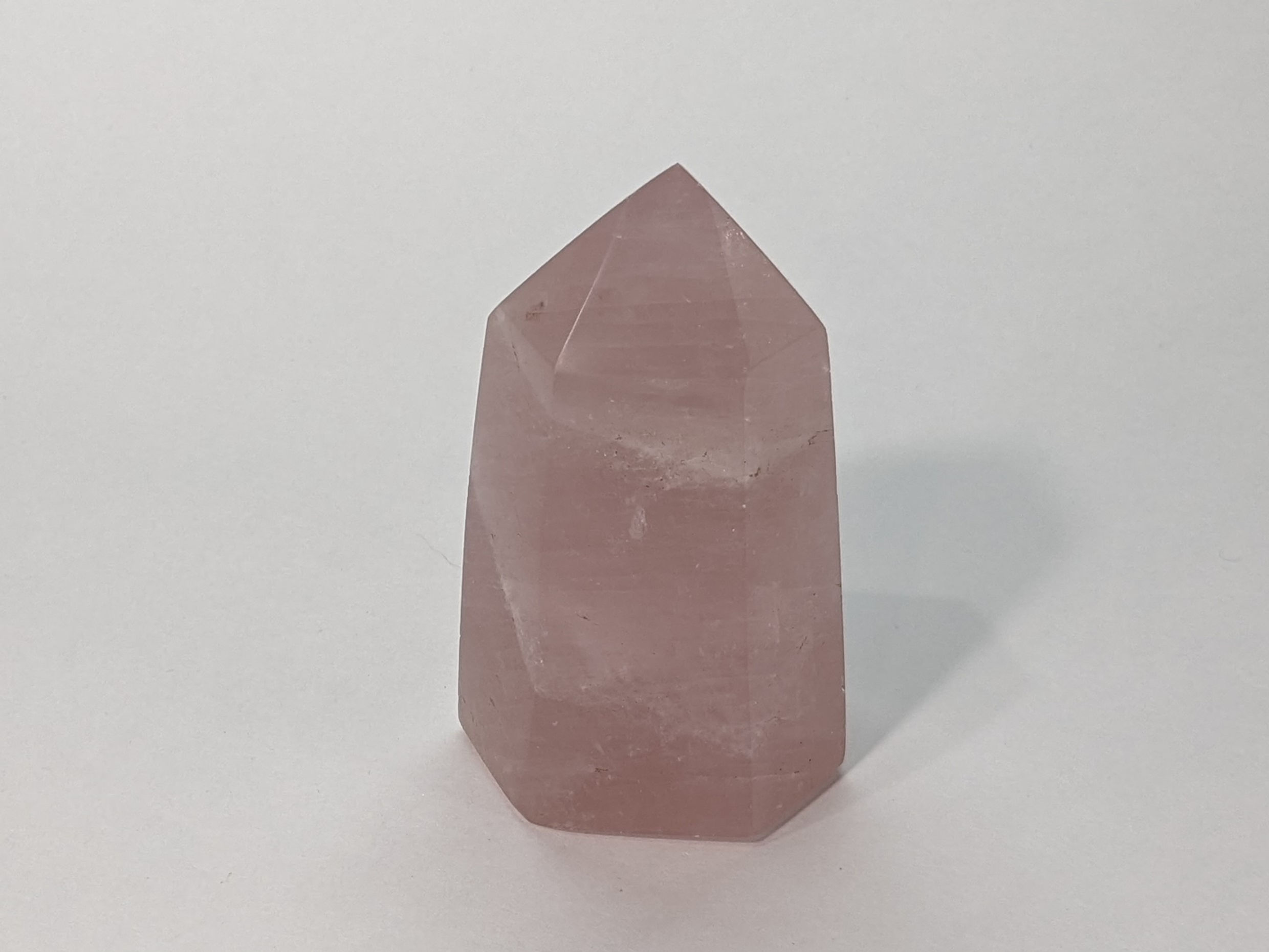 Polished rose quartz tower showcasing gentle pink hues and elegant form