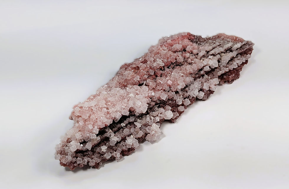 translucent halite crystal with pink tones and mineral formation