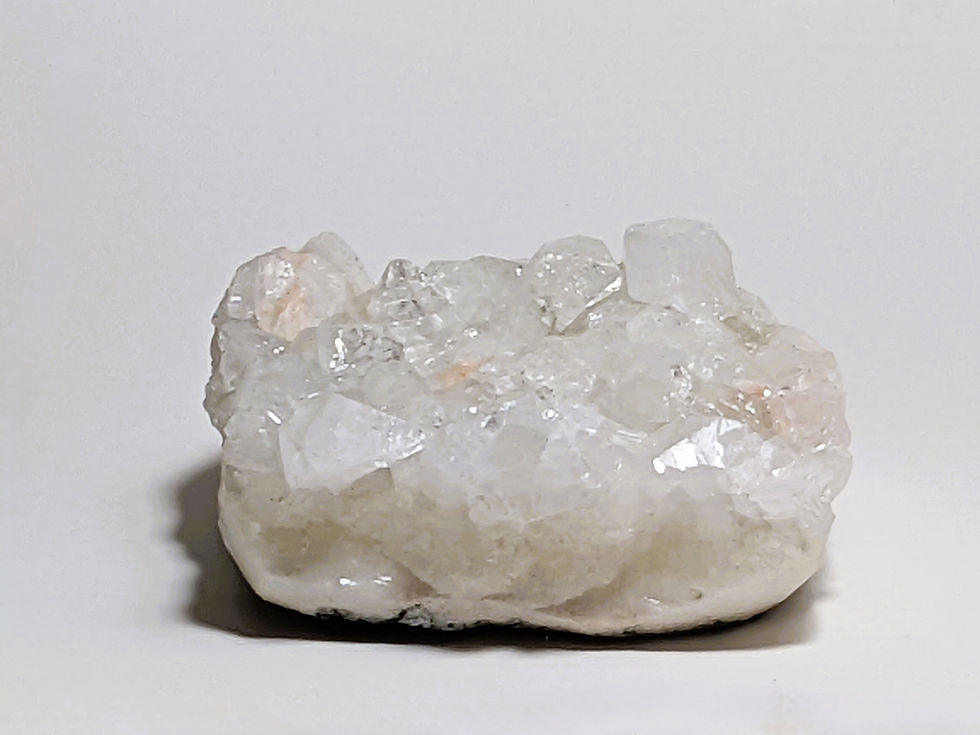 Thumbnail: Apophyllite and Stilbite specimen featuring intricate crystal formations and a shimmering surface.