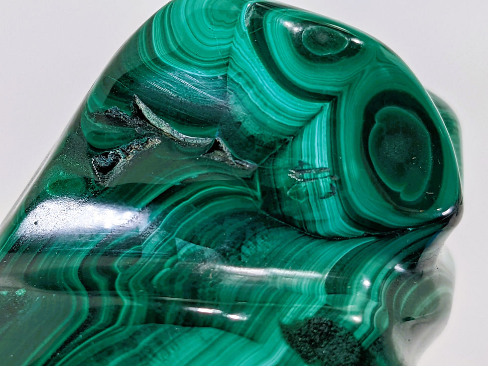 Thumbnail: Polished malachite freeform highlighting smooth, glossy textures with vivid green marbling and natural striations.