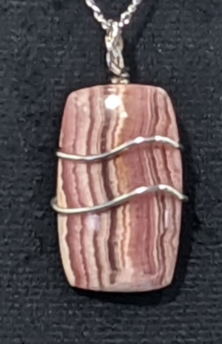 Thumbnail: Rhodochrosite pendant with pink color and natural banding patterns