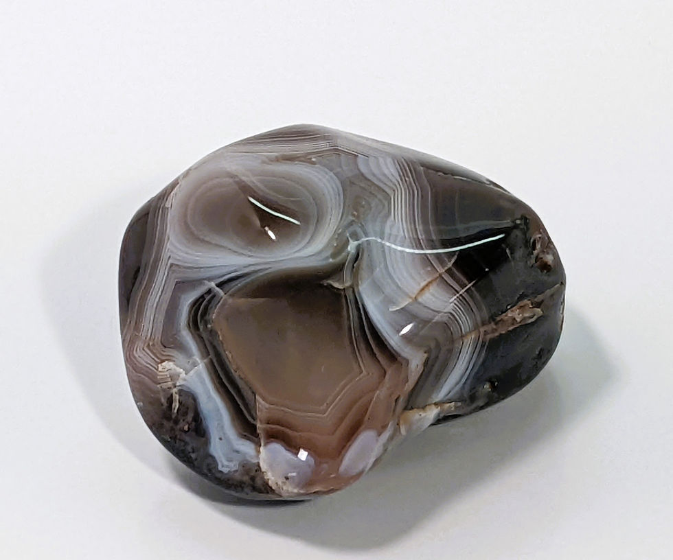 Thumbnail: Botswana Agate tumbles featuring intricate bands of cream, gray, and peach.