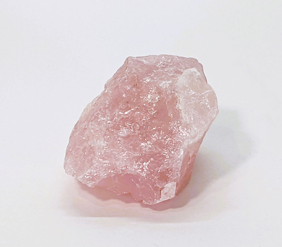 Rough rose quartz crystal with pale pink color and unpolished surface
