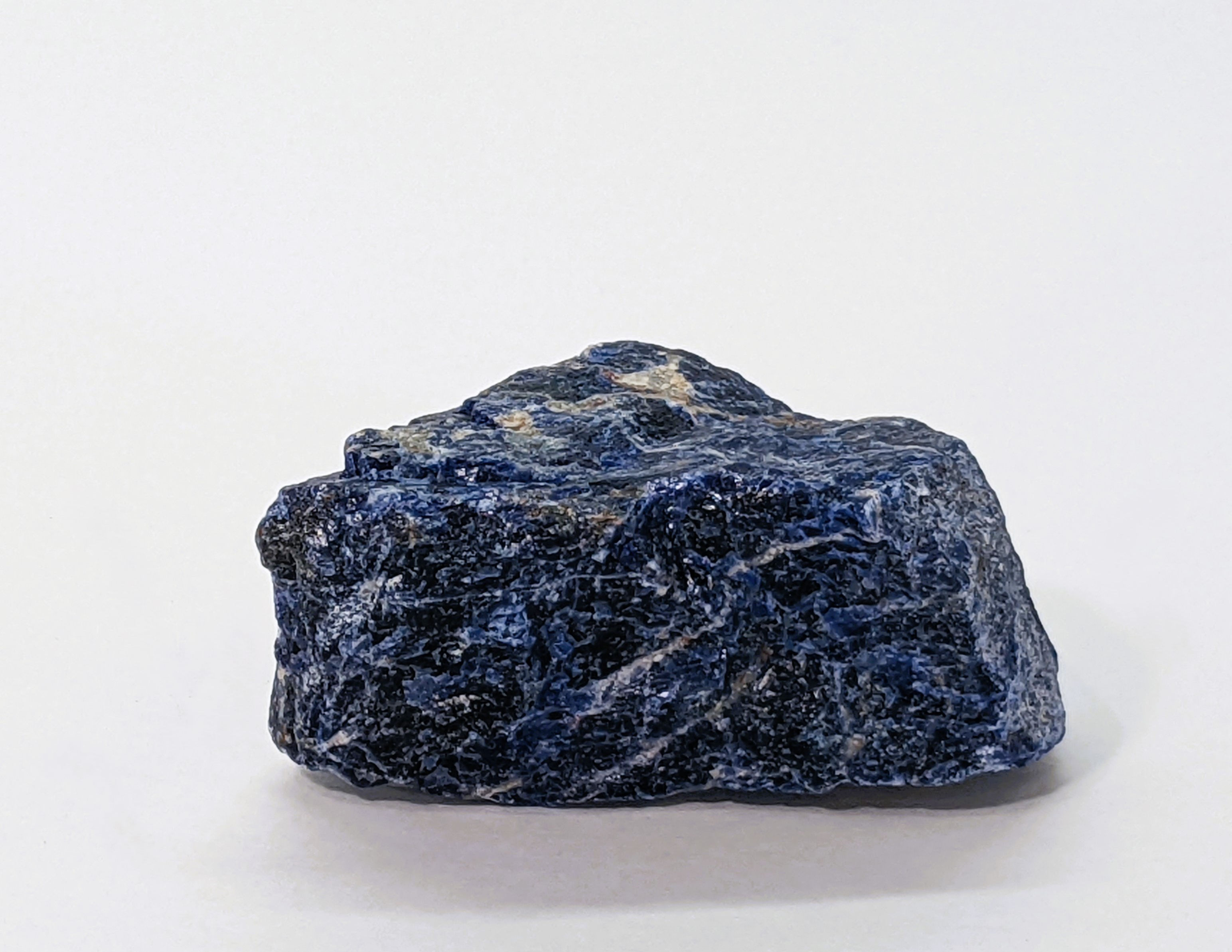 Rough Sodalite stone with bold blue hues and distinctive white streaks.