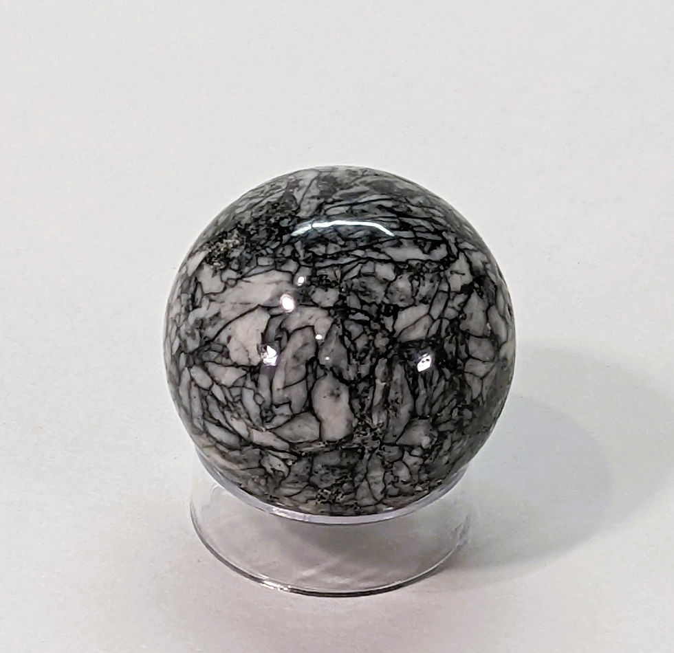 Thumbnail: Polished Pinolite sphere with natural black and white mineral patterns.