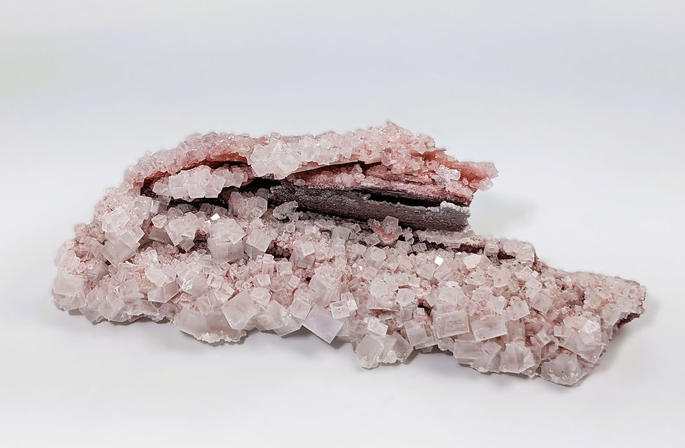 translucent halite crystal with pink tones and mineral formation