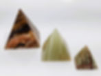 Trio of polished Onyx pyramids with natural banded layers in black, brown, and white, inspired by the Giza Plateau.