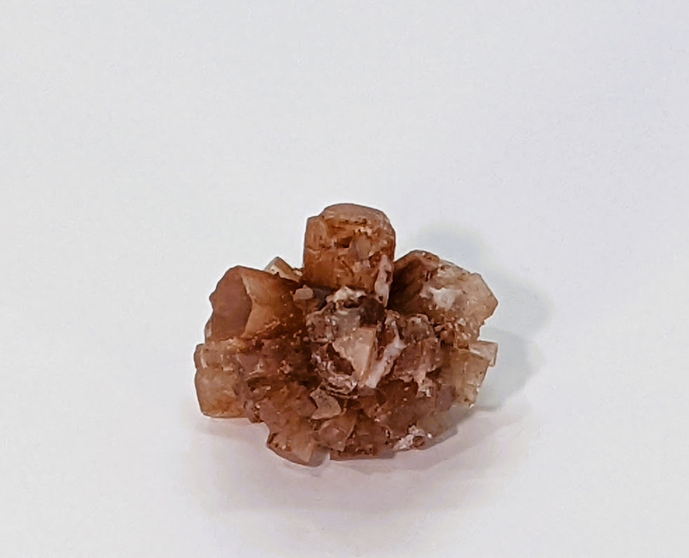 Thumbnail: Brownish-red Sputnik Aragonite specimen with starburst crystal shape.