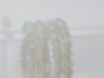 Opalite bracelet with smooth round beads reflecting soft milky blue and rainbow-like shimmer