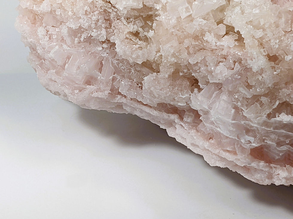 Thumbnail: Pink halite crystal with natural cubic structure and soft translucent glow