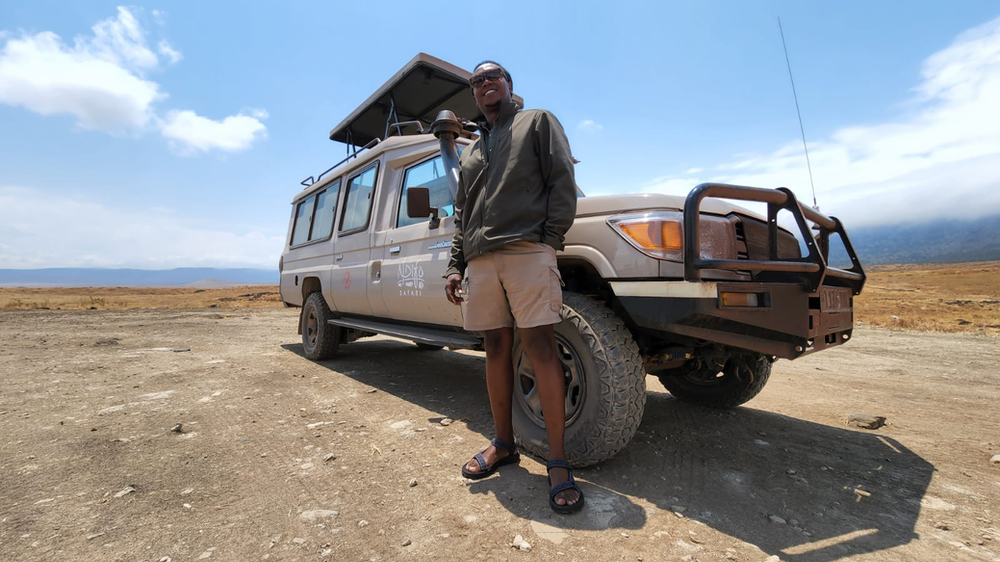 Steven Ngowi in front of Ndifo Safari Jeep