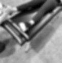 close up of legs of a woman on a table, with hands grabbing and pulling at the right foot